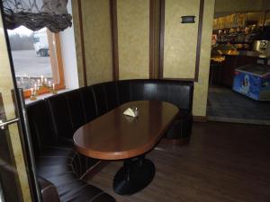 a wooden table in a restaurant with a table at Motel Sapnis in Jēkabpils