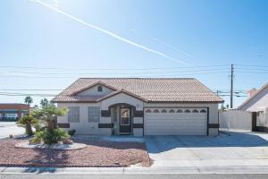 a house with a garage in a residential neighborhood at Modern Home! Pool & Jacuzzi (30% off for longterm) in Las Vegas