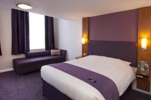 a hotel room with a large bed and a large window at Premier Inn London Stansted Airport in Stansted Mountfitchet