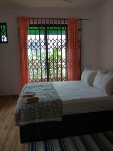 a bedroom with a large bed and a window at Beautiful House Spintex Road Accra in Accra