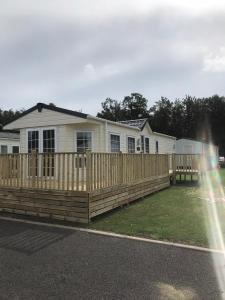 a wooden fence in front of a house at Cumbria Reach in Longtown