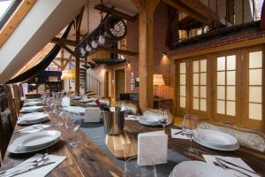 a dining room with a long table with wine glasses at Billionaires Club LOFT Sauna City Center in Prague