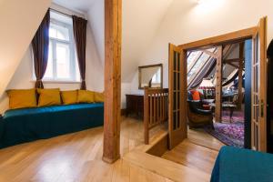 a living room with a blue couch and a window at Billionaires Club LOFT Sauna City Center in Prague