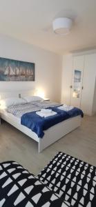 a bedroom with a large bed with a blue blanket at Apartments Katarina in Stara Novalja