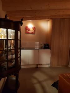 a kitchen with white cabinets and a counter top at B&B de Hinne in Holten