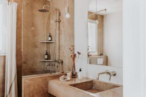 a bathroom with a sink and a shower at Casa Stellar - boutique villa with private heated pool and sea view - sustainably solar powered in Sant Josep de sa Talaia