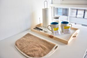 a wooden tray with two coffee mugs and a rug at Studio Congreso in Buenos Aires