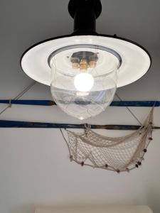 a light hanging from a ceiling with a net at Porto Antico in Bari