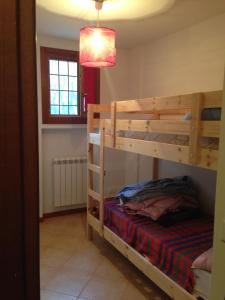 a bedroom with two bunk beds in a room at Adamello Ski Appartament in Vione