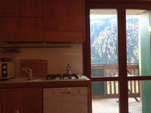 a kitchen with a view of a mountain at Adamello Ski Appartament in Vione