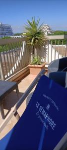 a blue sign sitting on top of a balcony at Le Sémaphore - studio climatisé, grande terrasse vue mer - parking, wifi in La Grande Motte