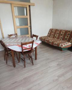 a living room with a table and a couch at Gîte La P'tite Fugue in Mareuil-sur-Cher