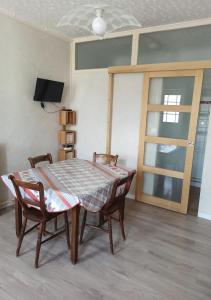 a dining room with a table and two chairs at Gîte La P'tite Fugue in Mareuil-sur-Cher