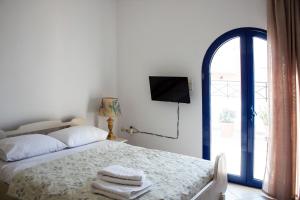 a bedroom with a bed with towels on it at Hara's Studio in Perdika