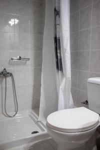a bathroom with a toilet and a shower at Hara's Studio in Perdika