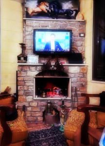 a living room with a fireplace with a flat screen tv at Top OverView Resort 