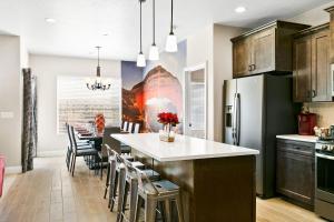 a kitchen with a large kitchen island with chairs at Zion Village Elements Fire in Hurricane