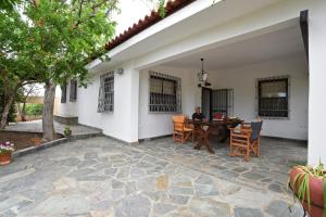 a man sitting at a table on a patio at Casa Mykines 