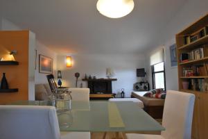 a dining room and living room with a table and chairs at Casa Mykines 