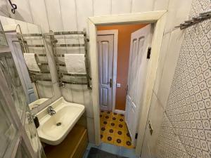 a small bathroom with a sink and a mirror at Old Lviv Apartment in Lviv