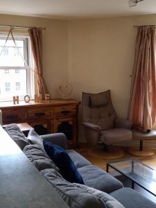 - un salon avec un canapé, une chaise et une fenêtre dans l'établissement 3 Bedrooms Flat in Central Edinburgh Old Town , Grassmarket Heart of Edinburgh Flat Sleeps 6 , EH1, à Édimbourg
