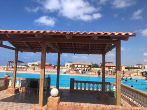 a pavilion at a resort with a swimming pool at Nice Chalet north coast , Kilo 59, Riviera resort in Dawwār ‘Abd Allāh