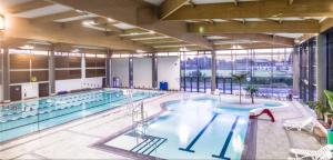 a large indoor swimming pool with a large window at Superbe appartement Arcachon in La Teste-de-Buch