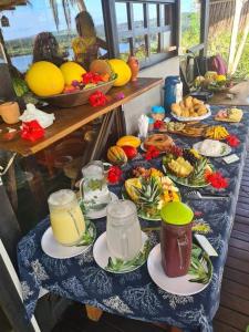 a table with many plates of food on it at Art Jungle Eco Lodge in Itacaré