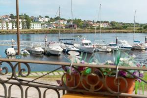a group of boats are docked in a marina at Naval Guest House & Bistrô in Vila do Conde