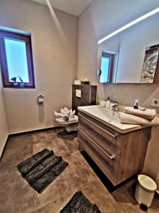 a bathroom with a sink and a mirror at Apart Isabella in Schwendau