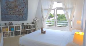 a white bedroom with a white bed and a window at STARBAL in Es Castell +90 photos