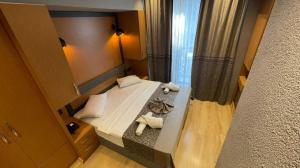 A bed or beds in a room at Grand Ambiance Hotel