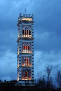 a tall building with lights on top of it at Cjase Paola in Cassacco