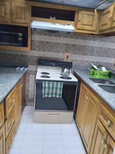 a kitchen with a stove with a tea kettle on it at Deluxe Montego Bay Club Studio & Suites in Montego Bay