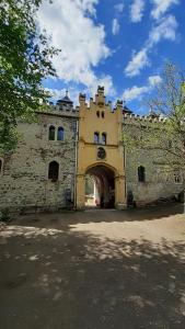 a building with an archway in front of it at Apartmány RADOST in Kovářská