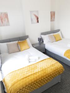 two beds sitting next to each other in a room at L.F.C Townhouse in Anfield in Liverpool