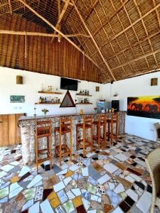 un bar en un complejo con suelo de mosaico en Mimi na wewe villa, en Nungwi