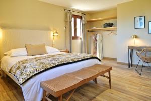 a bedroom with a large bed and a table at COCO in Venaco