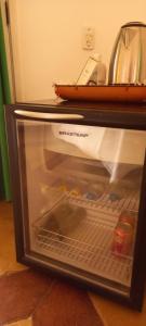 a refrigerator with its door open with food inside at Casa da Ilha & SPA in Abraão