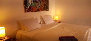 a white bed with two pillows in a room at Casa da Ilha & SPA in Abraão
