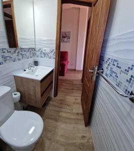 a bathroom with a white toilet and a sink at Casa Isidoro in Valle Gran Rey