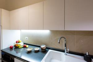 a kitchen with a sink and some fruit on a counter at San Giovanni Apartment in San Gimignano