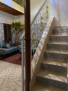 a stairway with blue and white tiles on the stairs at Dar Dikrayat in Marrakech
