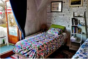 a bedroom with a bed and a book shelf at Nahlboms in Sandefjord