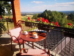 uma mesa e cadeiras numa varanda com flores em Rural holiday house Vinodol-Kalnik em Kalnik