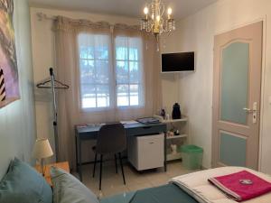 a room with a desk and a bed and a window at Le Mas des Collines 2 personnes in Rousset-les-Vignes