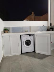 a washing machine under a counter in a kitchen at Marga STUDIO H10 in Arona