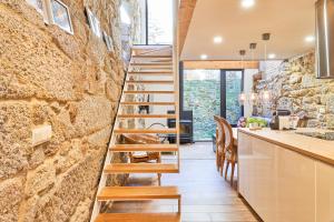 a staircase leading to the kitchen and dining room of a house at La casita de Singulis in Cangas de Morrazo