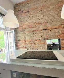 a brick wall in a kitchen with a fireplace at Get-your-flat - traumhafte Architekten-Wohnung Kaiserviertel Innenstadt 110m2 Haustier auf Anfrage - TOP in Dortmund