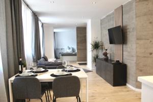 a living room with a table and chairs in a room at Vier Sind Hier Apartments in Rottweil